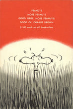 Load image into Gallery viewer, The back cover of the book featuring an orange and white circular design resembling a rising or setting sun behind Snoopy in a field of tall grass. A list of additional Peanuts titles is printed in white near the top, along with the original retail price of $1.00 each.