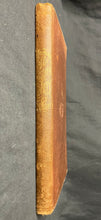 Load image into Gallery viewer, Spine of a brown cloth book with printed gold title typography showing mild wear at the top and bottom edges.