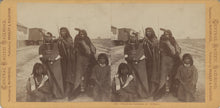 Load image into Gallery viewer, Yellow card stereoview mount with two albumen photographs of five blanketed Shoshone Indians in Corinne, Utah, by Eadweard Muybridge.