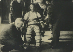 Original Silver Print Photograph Titled "Strapping the Victim Into the Death Chair;" Convicted Murderer Arthur Mayhew, Moments Before Being Executed