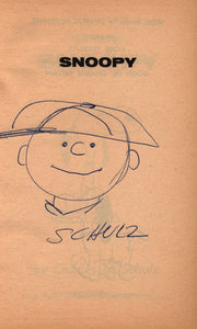 A New Peanuts Book Featuring Snoopy. [Signed by Schulz With an Original Sketch of Charlie Brown]